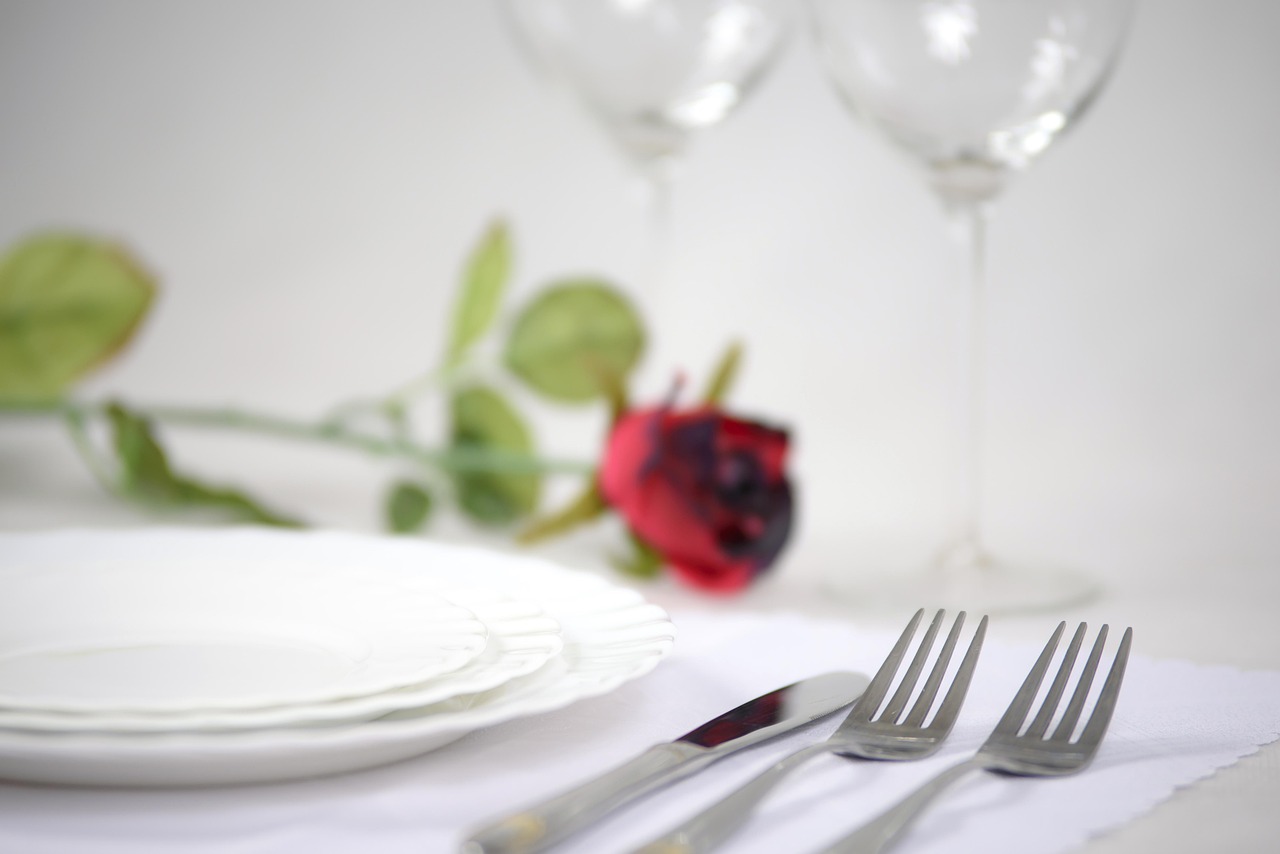 An elegant restaurant dining room with white tablecloths and place settings